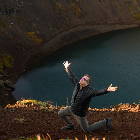 Man posing at Kerid Volcanic Crater, Grimsnes- og Grafningshreppur, Southern Region, Icelandのeditorial素材
