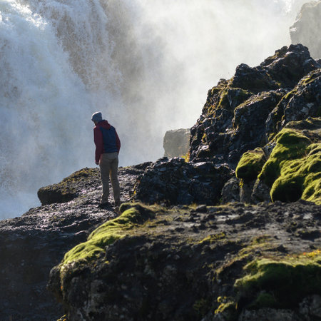 Tourist at Kolufossar Falls, Kolugljufur Gorge, Hunathing Vestra, Northwestern Region, Icelandのeditorial素材