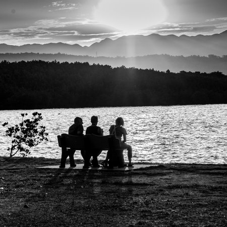 People sitting on bench at oceanside, Port Douglas, Queensland, Australiaのeditorial素材