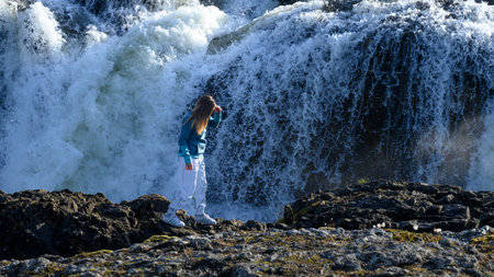 Tourist at Kolufossar Falls, Kolugljufur Gorge, Hunathing Vestra, Northwestern Region, Iceland