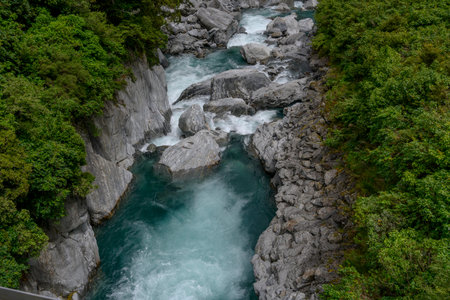 Elevated view of waterfall, Gates of Haast, Mt. Aspiring National Park, Makarora, Wanaka, Otago Region, South Island, New Zealandのeditorial素材