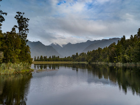 Lake with mountain range in the background, Lake Matheson, West Coast, South Island, New Zealandのeditorial素材