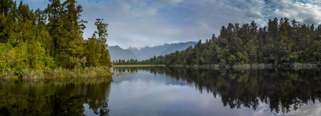 Lake with mountain range in the background, Lake Matheson, West Coast, South Island, New Zealandのeditorial素材