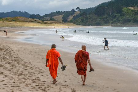Two monks walking on beach, Hot Water Beach, The Coromandel, North Island, New Zealandのeditorial素材