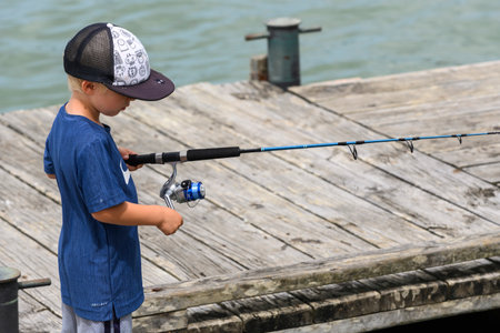 Boy with fishing rod on pier, Opua, Bay of Islands, Northland, North Island, New Zealandのeditorial素材