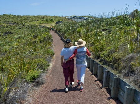 Two people walking on track near Cape Reinga the Northwesternmost tip of the Aupouri Peninsula, North Island, New Zealandのeditorial素材