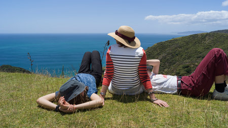 Tourists resting on hill, North Easternmost Tip, Aupouri Peninsula, Cape Reinga, North Island, New Zealandのeditorial素材