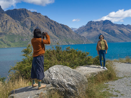 Woman taking picture of her friend, Devil's Staircase Lookout Point, North Island, New Zealandのeditorial素材