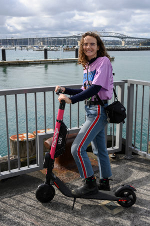 Woman standing with push scooter, Wynyard Quarter, Auckland, North Island, New Zealandのeditorial素材
