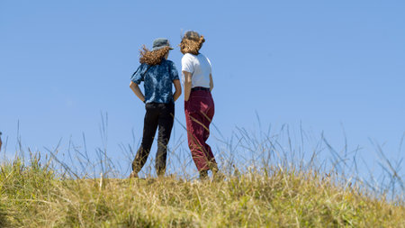 Two women standing on a hill, North Easternmost Tip, Aupouri Peninsula, Cape Reinga, North Island, New Zealandのeditorial素材