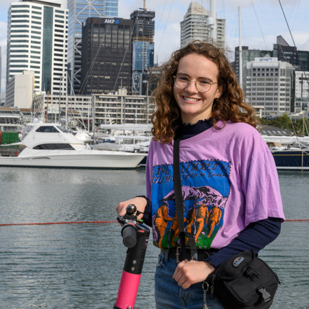 Woman standing with cityscape in background, Wynyard Quarter, Auckland, North Island, New Zealandのeditorial素材
