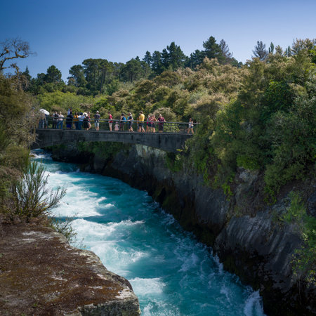 Tourists standing on footbridge over The Huka Falls, Waikato River, Lake Taupo, North Island, New Zealandのeditorial素材