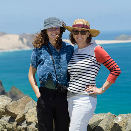 Woman posing with her daughter standing on the coast, North Easternmost Tip, Aupouri Peninsula, Cape Reinga, North Island, New Zealandのeditorial素材