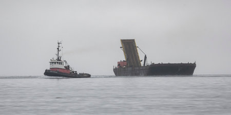 Tug boat with a ship in the Johnstone Strait, North Vancouver Island, British Columbia, Canadaのeditorial素材