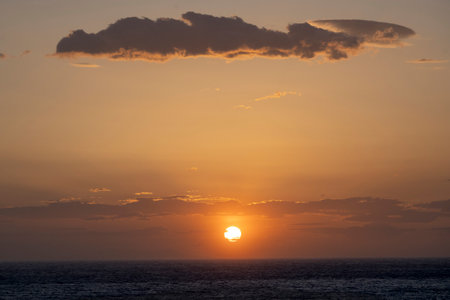 Scenic horizon view of the sun setting on the Aegean Sea, Mykonos Greeceのeditorial素材
