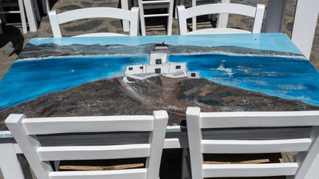 Illustration painting on a tabletop at an outdoor restaurant, Ano Mera, Mykonos, Greece