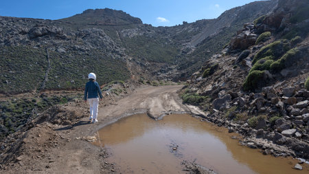 Female tourist walking along a path on Mykonos Island, Greeceのeditorial素材