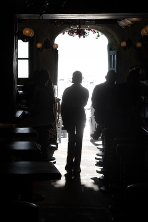 Silhouettes of people inside a building, Mykonos Town, Mykonos Island, South Aegean, Greeceのeditorial素材