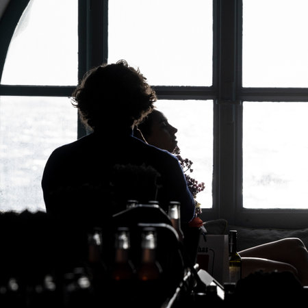 Silhouette of a couple sitting in front of a window, Mykonos Town, Mykonos Island, South Aegean, Greeceのeditorial素材