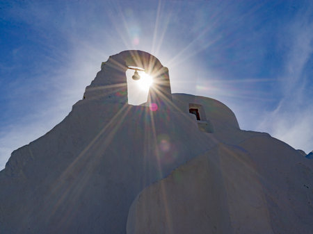 Sunlight glowing through a bell tower on a church in Mykonos Town on Mykonos Island, Greeceのeditorial素材