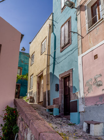 Sloped cobblestone walkway along buildings in the Town of  Bosa, Sardinia, Italyのeditorial素材