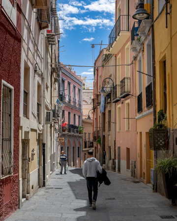 Man walking on a narrow street in the city of Cagliari, Sardinia, Italyのeditorial素材
