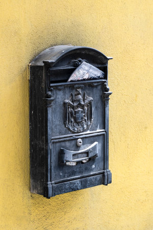 Metal mailbox on an exterior yellow wall, Cagliari, Sardinia, Italyのeditorial素材