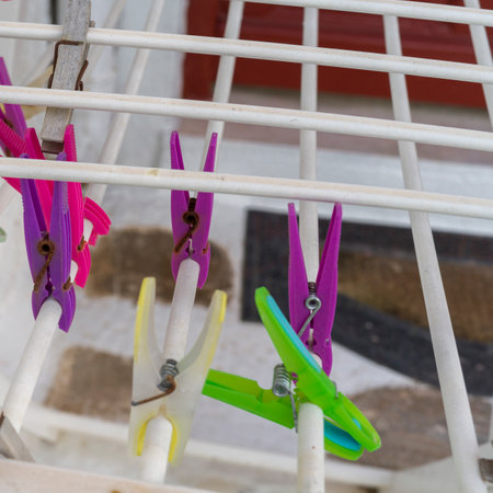Colorful clothes pins clipped to a clothes line in Mykonos Town, Mykonos Island, Greece