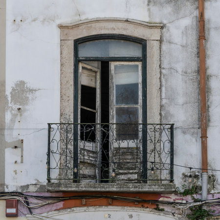 Balcony and doors on the exterior wall of a building in SetÃºbal which is a busy port and industrial city in Portugal that boasts an extensive history and rich seafaring heritageのeditorial素材