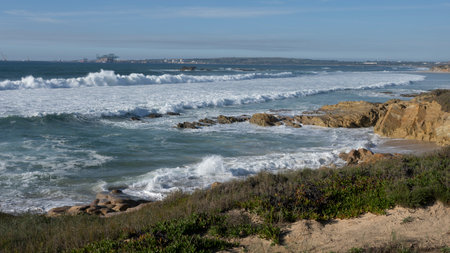 Waves splashing along the shoreline of the Coast south of Sines, Porto Covo, Setubal, Portugal that is also a popular beach spot and the main fishing harbour of Alentejo regionのeditorial素材