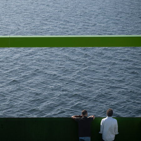 Tourists on a ferry ship travelling along the ocean coastline from Setubal across the water to Costa de Gale, Portugalのeditorial素材