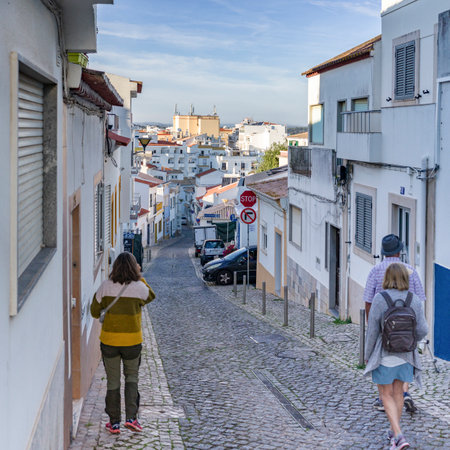 Slopped narrow cobblestone road through the village of Lagos, Faro, Portugal,のeditorial素材