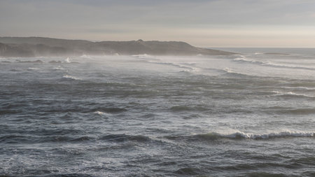 Waves splashing along the shoreline of Farol de Milfontes Rio Mira, Beja, Portugalのeditorial素材