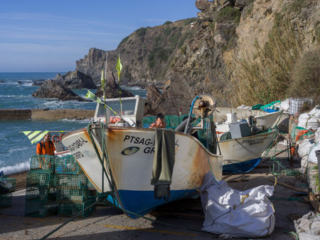 Fishermen with their fishing boats on the beach at Alentejo Litoral, Algarve, SÃ£o TeotÃ³nio, Mirador azenha do ma, Beja, Portugal, SetÃºbal District Southern Regionsのeditorial素材