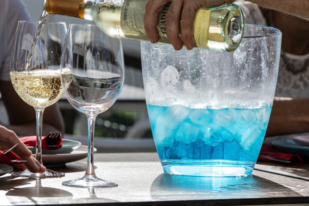 Wine being poured from a bottle into wine glasses on a table, SÃ£o TeotÃ³nio, Beja, Algarve, Portugalのeditorial素材