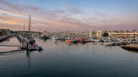 Boats moored along the waterfront of Lagos which is a town in southern Portugal's Algarve region. Itâs known for its walled old town, cliffs and Atlantic beachesのeditorial素材