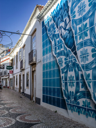 Pattern in blue symbols painted on the exterior of a building in Lagos that is a town in southern Portugal's Algarve region known for its walled old town, cliffs and Atlantic beachesのeditorial素材
