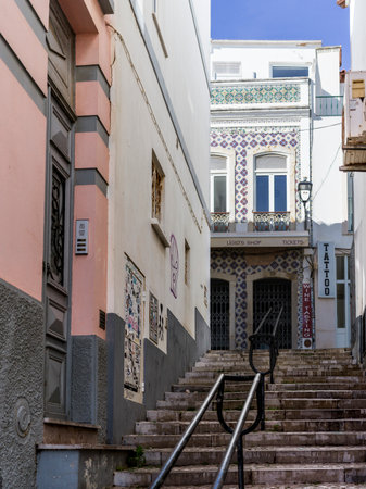 Buildings with a narrow lane of stairs in the town of Lagos in southern Portugal's Algarve region, known for its walled old town, cliffs and Atlantic beachesのeditorial素材