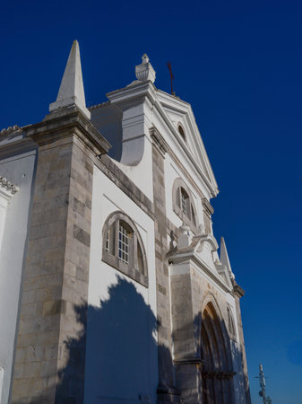 Upward view of a church exterior in Tavira which is a small city on Portugalâs Algarve coast that straddles the GilÃ£o Riverのeditorial素材