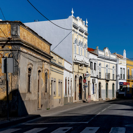Buildings along a cobblestone street in Luz, Faro, Portugalのeditorial素材