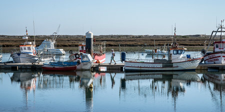 Boats docked along a pier in Santa Luzia Tavira that is considered the "capital do Polvo" or "capital of octopus" which is a local speciality, Santa Luzia, Faro, Portugalのeditorial素材