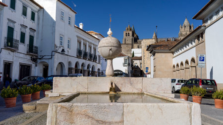 Fountain in a plaza amongst buildings in Evora, which is the capital of Portugal's south-central Alentejo regionのeditorial素材