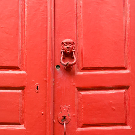 Door knocker on red exterior door of a building in Mykonos Town, Mykonos Island, Greeceのeditorial素材
