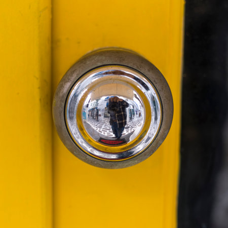 Shiny reflective door knob on a yellow door in Mykonos Town, Mykonos Island, Greeceのeditorial素材
