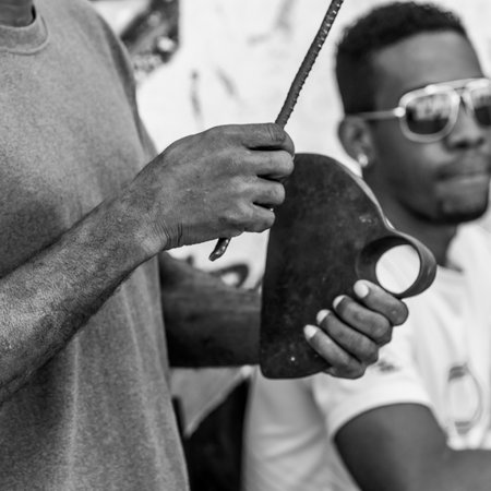 Close-up of a man holding pieces of metal, Havana, Cubaのeditorial素材