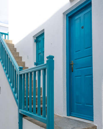 Blue entrance door and staircase on the exterior of a building in Mykonos Town, Mykonos Island South Aegean, Greeceのeditorial素材