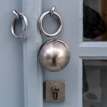 Shiny round doorknob on the exterior of a door in Mykonos Town, Mykonos Island, Greeceのeditorial素材
