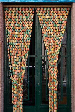 Beaded curtain in front of a doorway in the town of Bosa which is situated about two-thirds of the way up the west coast of Sardinia, Italyのeditorial素材