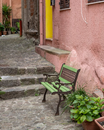 Bench in a lane outside a bulding in Castelsardo, Northwest on the Sardinia Island, Italyのeditorial素材