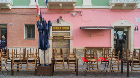 Exterior of a restaurant with streetside  table and chairs, Carloforte Town, South Sardina, Italyのeditorial素材